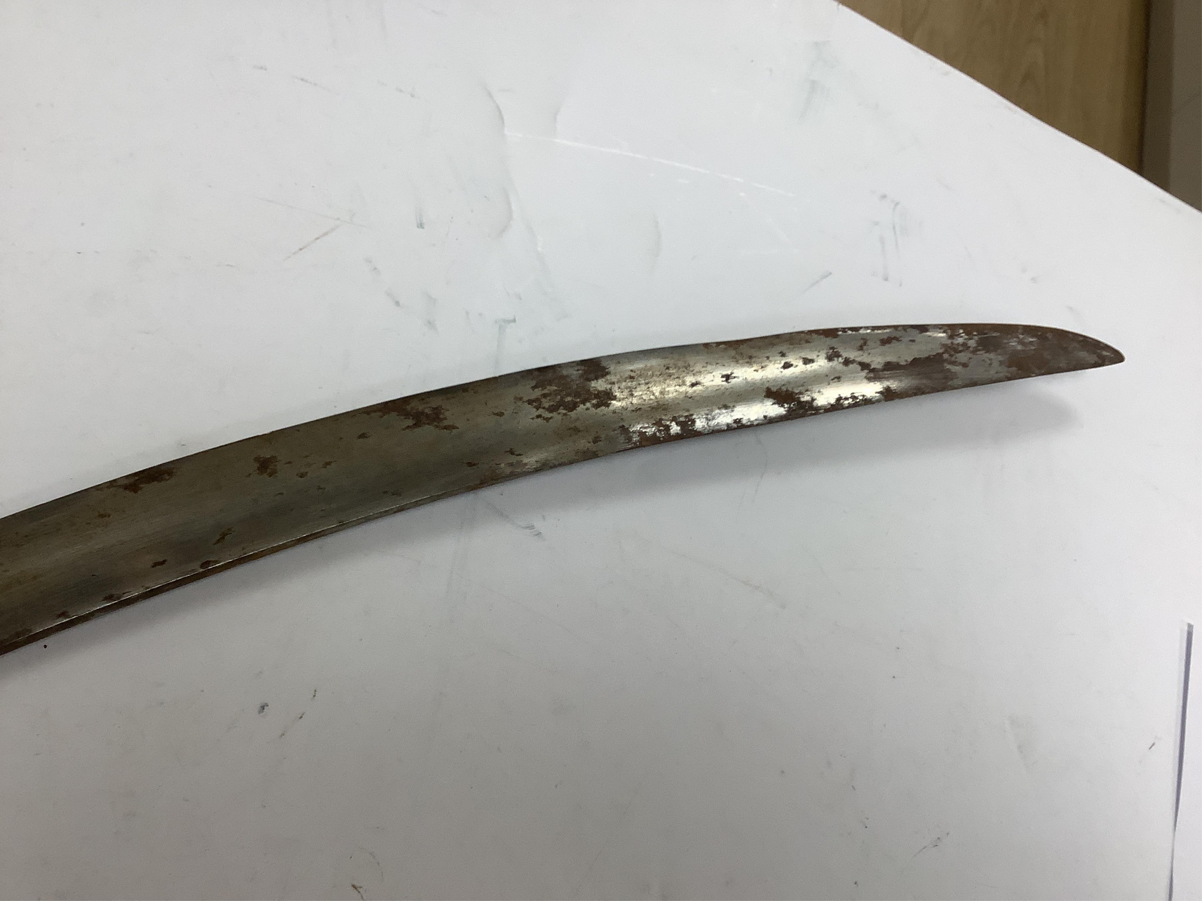 An Indian Tulwar sword, in scabbard and two small kukri, largest 93cm long.